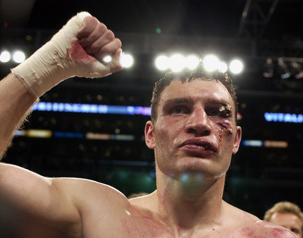 Vitali Klitschko holds up his fist after losing the WBC/IBO heavyweight championship bout to Lennox Lewis Saturday, June 21, 2003, in Los Angeles. Lewis won by TKO when the fight was stopped after the sixth round because of the cut to Klitschko's left eye. (AP Photo/Mark J. Terrill)
