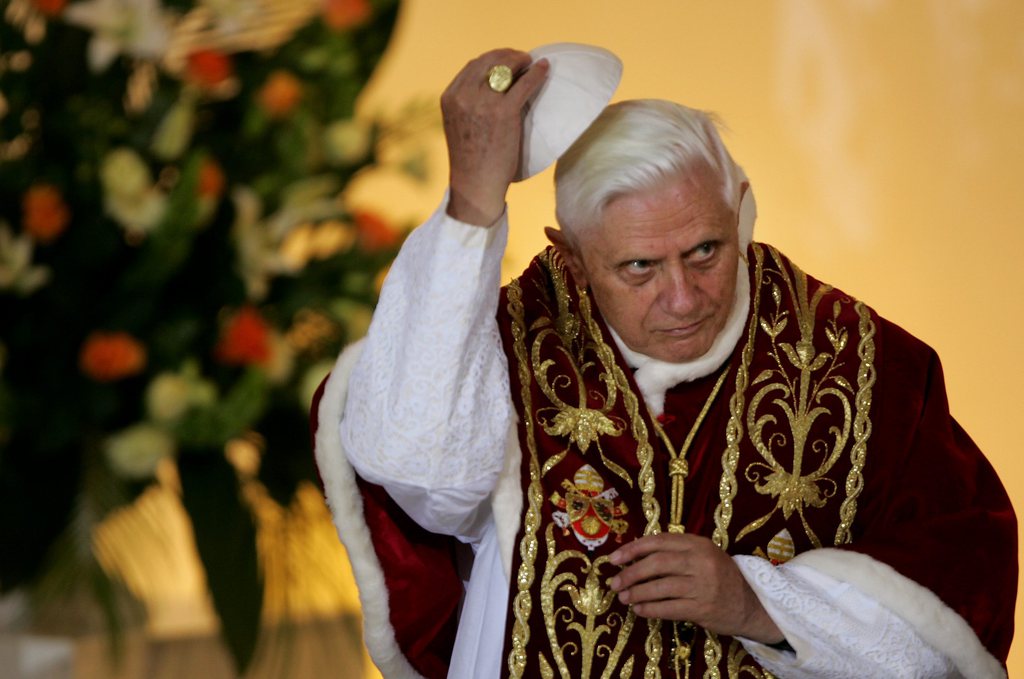 FILE - This May 25, 2006 file photo shows Pope Benedict XVI lifting his scull cap during an ecumenical meeting at the Holy Trinity church in Warsaw, Poland. On Monday, Feb. 11, 2013 Benedict XVI announced he would resign Feb. 28, the first pontiff to do so in nearly 600 years. The decision sets the stage for a conclave to elect a new pope before the end of March. (AP Photo/Diether Endlicher, file)