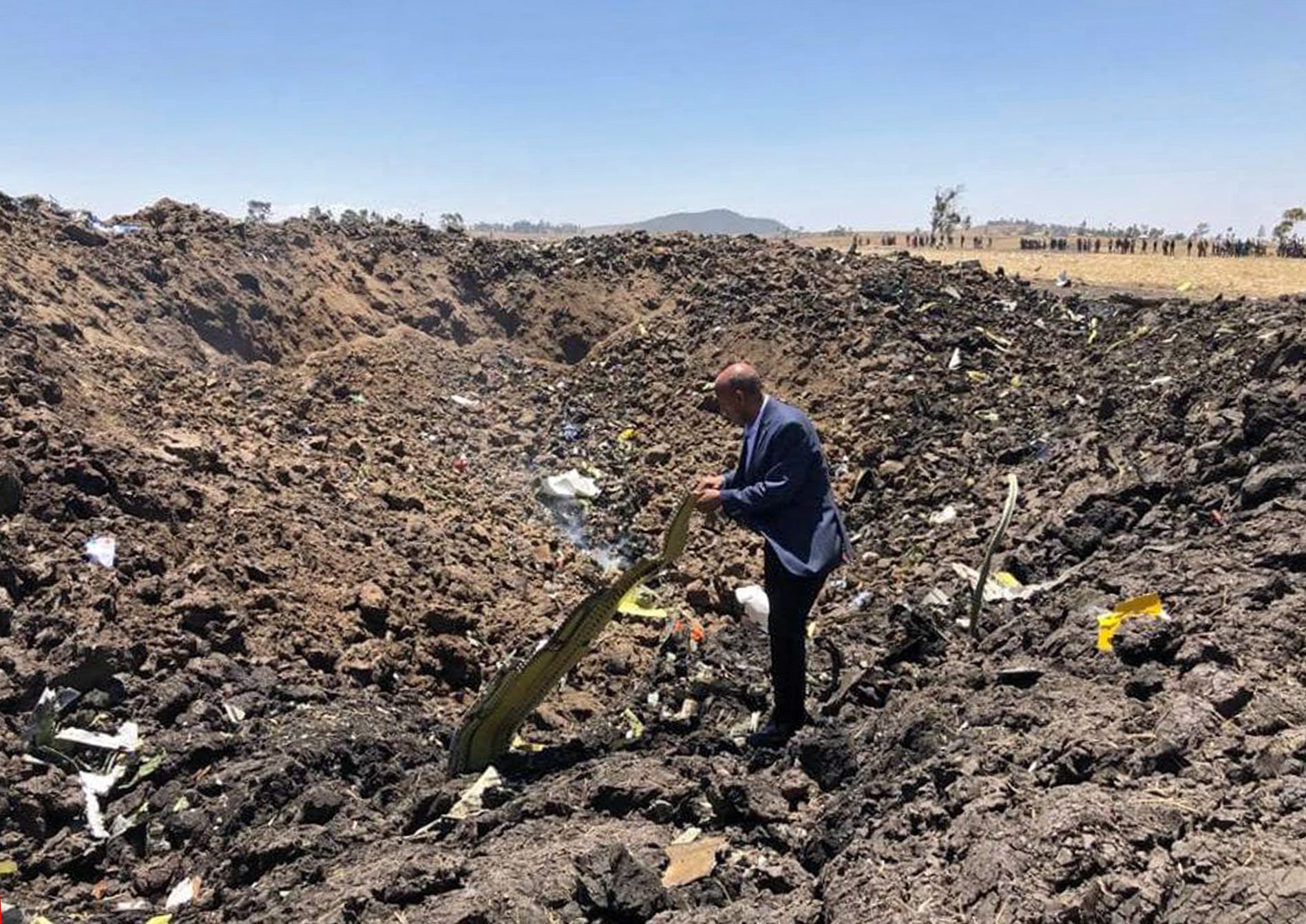 epa07426966 A handout photo made available by Ethiopia Airlines shows the Ethiopian carrier's CEO Tewolde GebreMariam posing among debris at the crash site of Ethiopian Airlines Boeing 737 Max 8 en route to Nairobi, Kenya, crashed near Bishoftu, Ethiopia, 10 March 2019. All passengers onboard the scheduled flight ET 302 carrying 149 passengers and 8 crew members, have died, the airlines says.  EPA/Ethiopia Airlines / HANDOUT  HANDOUT EDITORIAL USE ONLY/NO SALES ETHIOPIA KENYA PLANE CRASH