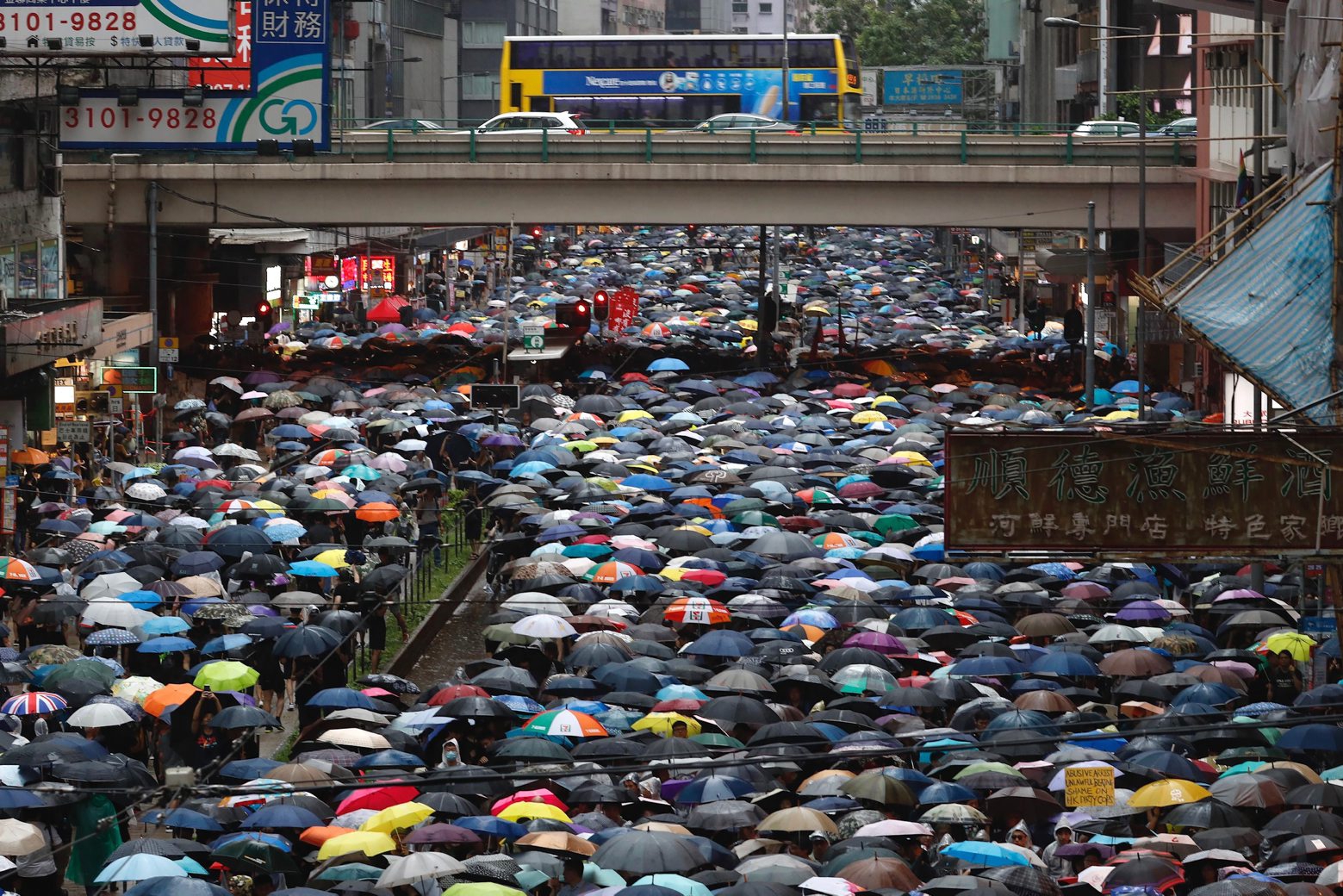 Demonstrators carry umbrellas as they march along a street in Hong Kong, Sunday, Aug. 18, 2019. Heavy rain fell on tens of thousands of umbrella-ready protesters as they started marching from a packed park in central Hong Kong, where mass pro-democracy demonstrations have become a regular weekend activity. (AP Photo/Vincent Yu) Hong Kong Protests