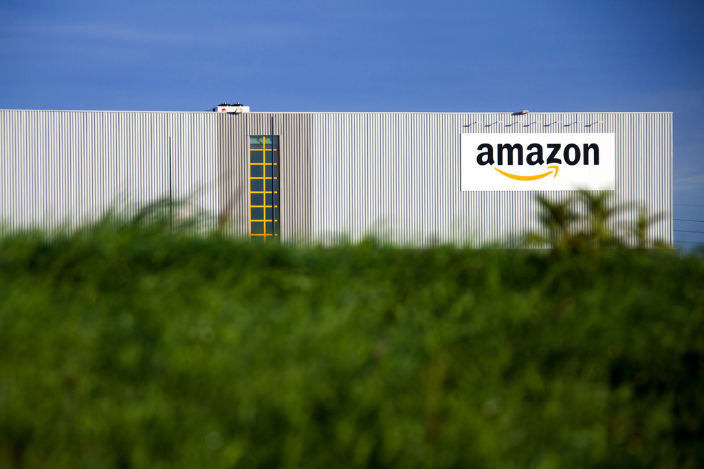 This Sept.19, 2013 photo shows the logistics center of online merchant Amazon in Lauwin-Planque, northern France. The Organization for Economic Cooperation and Development released a plan Monday, Oct.5, 2015 to end tax shelters and require companies to pay taxes in the countries where they earn profits, among other measures. Google, Facebook, Starbucks and Amazon are among many companies criticized for shifting profits to low-tax jurisdictions. (AP Photo/Michel Spingler)